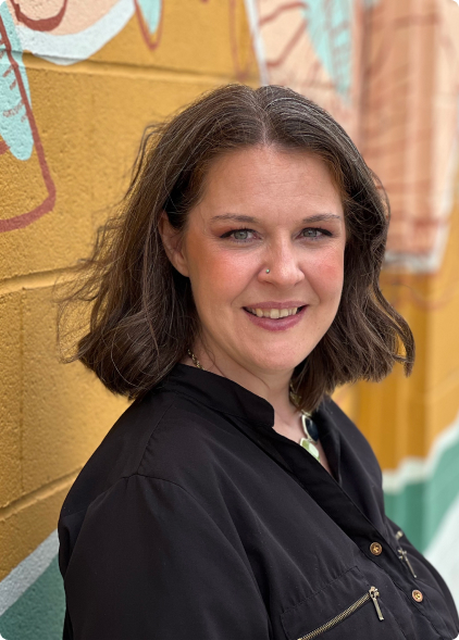 Amy Townsend standing by brick wall